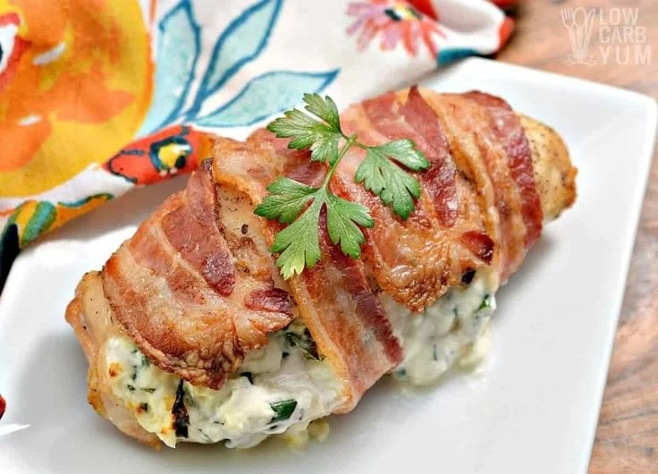Bacon-wrapped cream cheese stuffed chicken dish on a plate