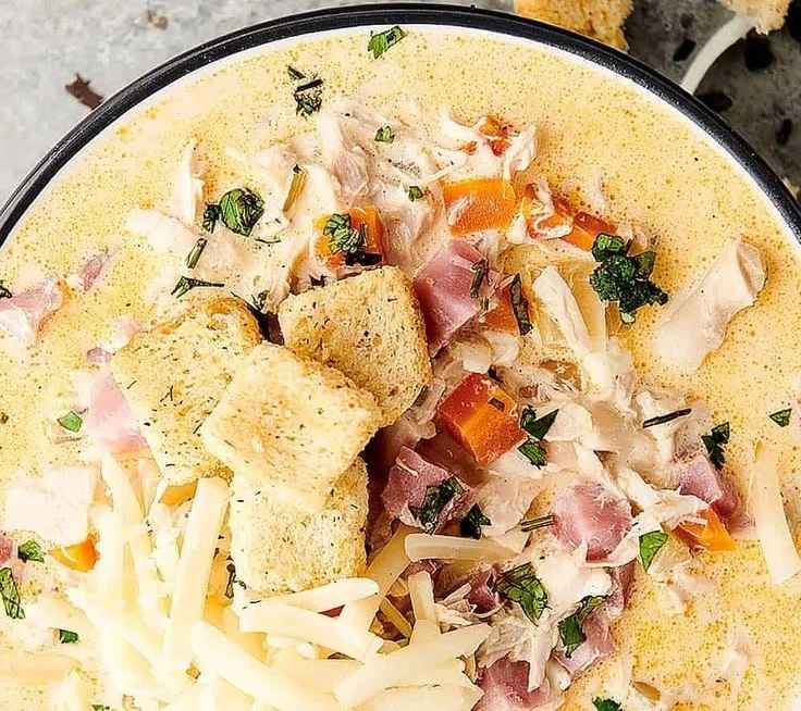 Delicious Chicken Cordon Bleu Soup in a bowl with ingredients around