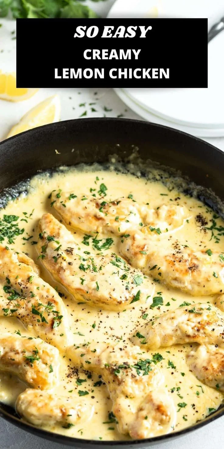 Delicious creamy lemon chicken served with herbs and lemon slices.