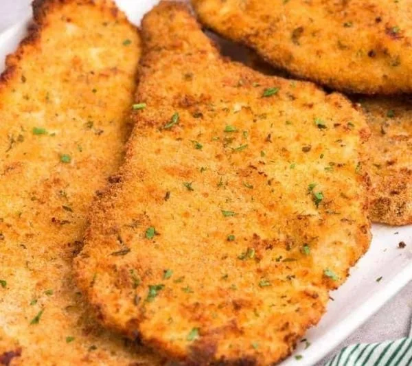 Crispy air fryer chicken cutlets served with a side salad