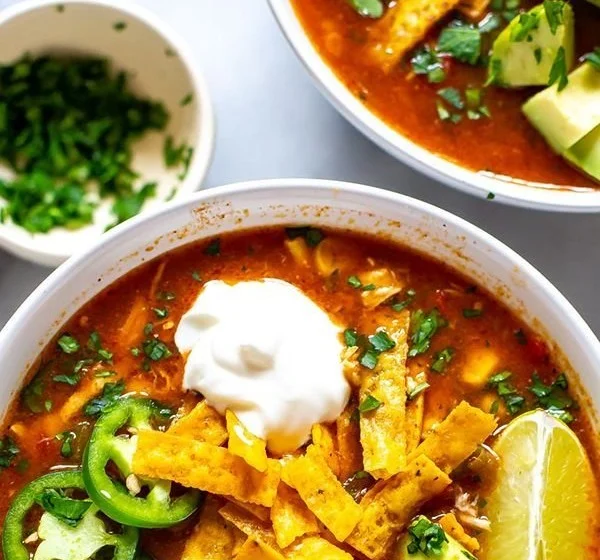 Delicious Crockpot chicken tortilla soup garnished with tortilla strips