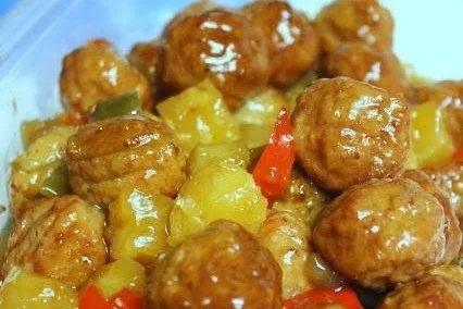 Crockpot Hawaiian Meatballs with pineapple and BBQ sauce served on a plate
