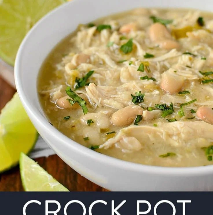 Delicious bowl of CrockPot white chicken chili topped with cilantro and lime