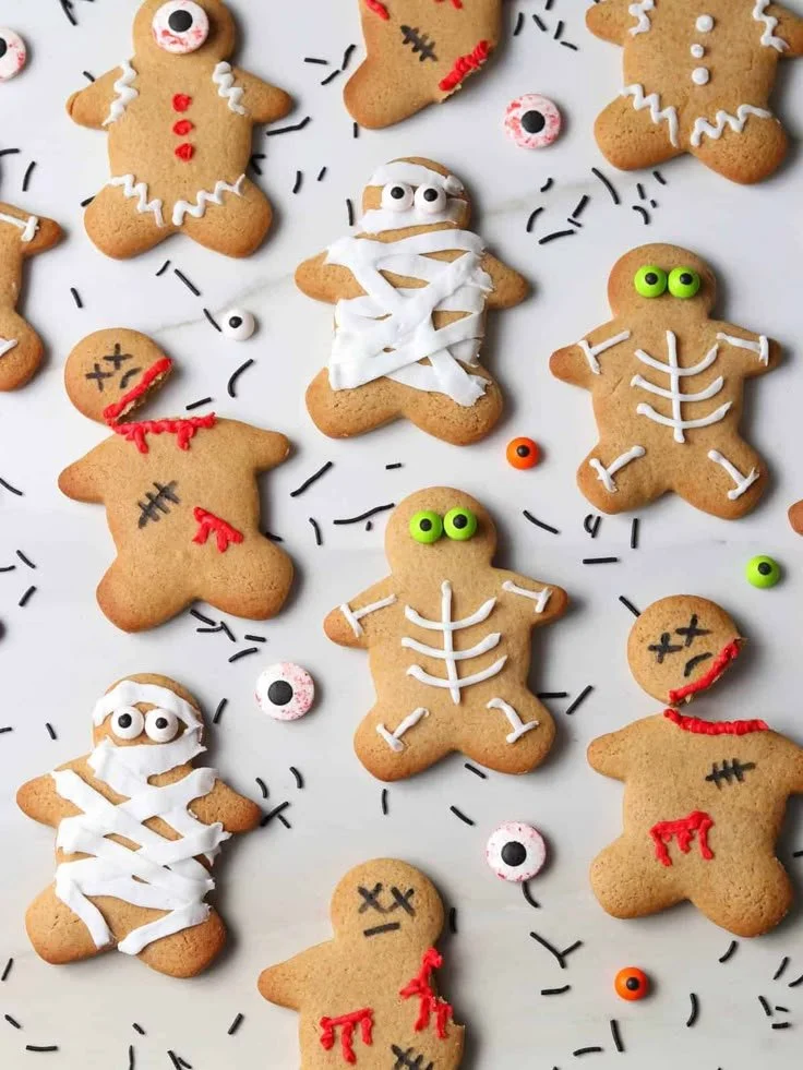 Halloween-themed Gingerbread Men decorated with spooky designs.