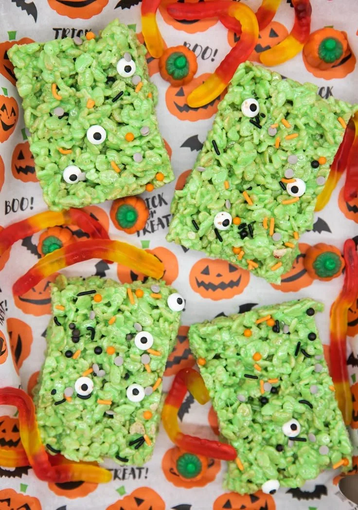 Colorful Halloween rice krispie treats decorated with spooky designs.