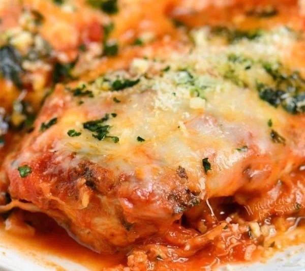 Instant Pot Chicken Parmesan garnished with fresh basil and served with spaghetti.