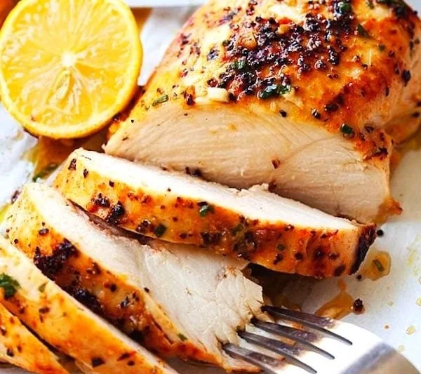 Deliciously cooked boneless chicken breasts on a plate.