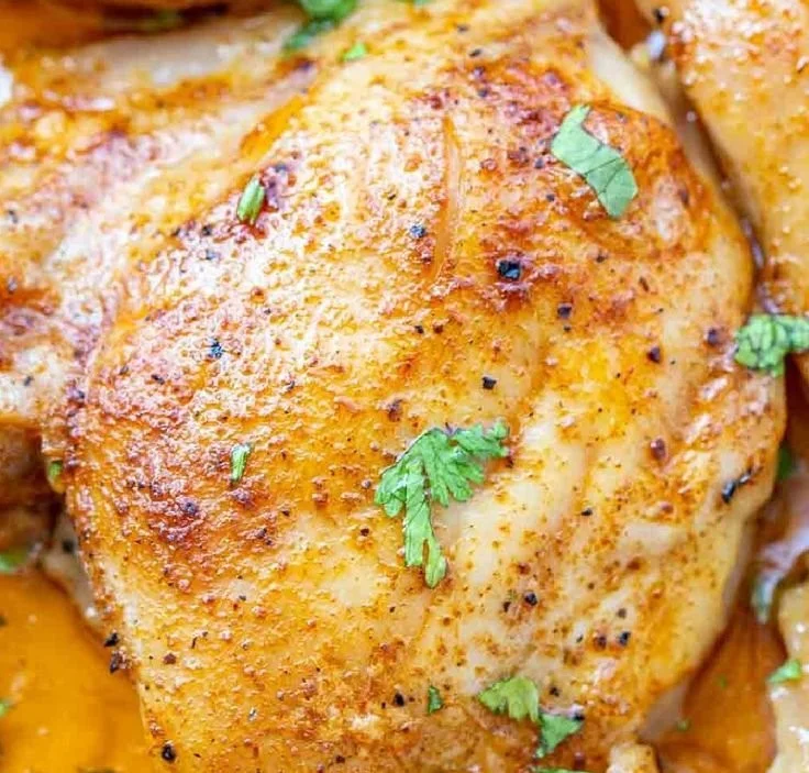 Oven-baked chicken thighs seasoned and roasted until golden brown