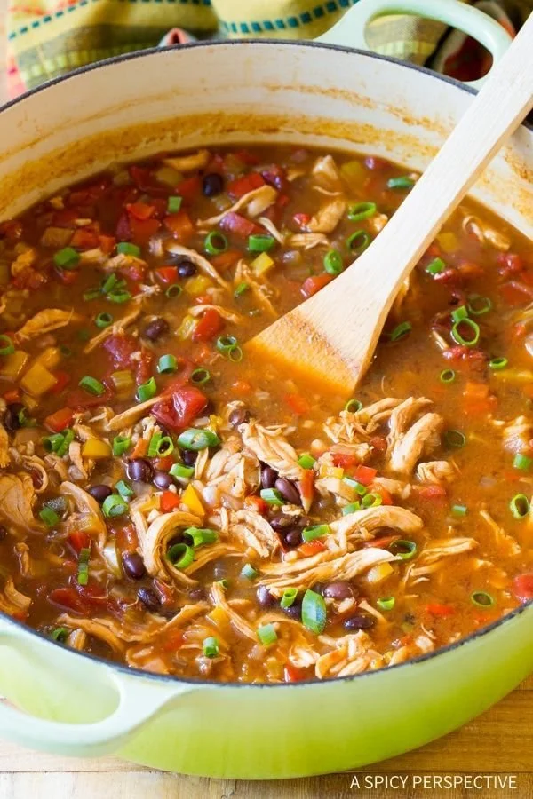 Bowl of skinny chicken fajita soup with colorful peppers and herbs