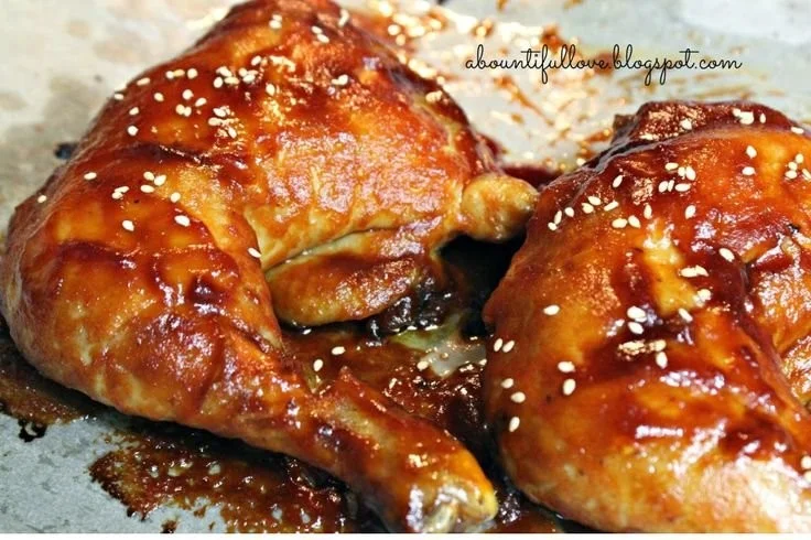 Delicious sticky chicken glazed with a flavorful sauce, served on a plate.