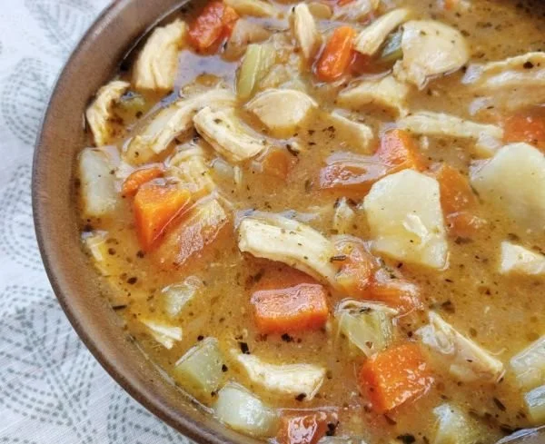 Delicious bowl of Tuscan Chicken Stew with herbs and vegetables